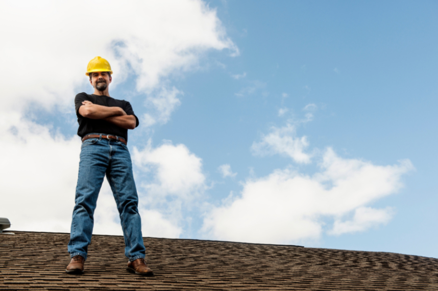 Local roofer standing on a finished Tulsa roof