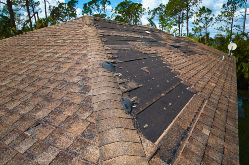 Roofer documenting storm damage on a Tulsa roof